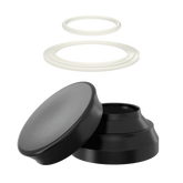 Zerlegbarer schwarzer Deckel mit zwei weißen Dichtungsringen für Pappdosen, zeigt Einzelteile in der Schwebe.